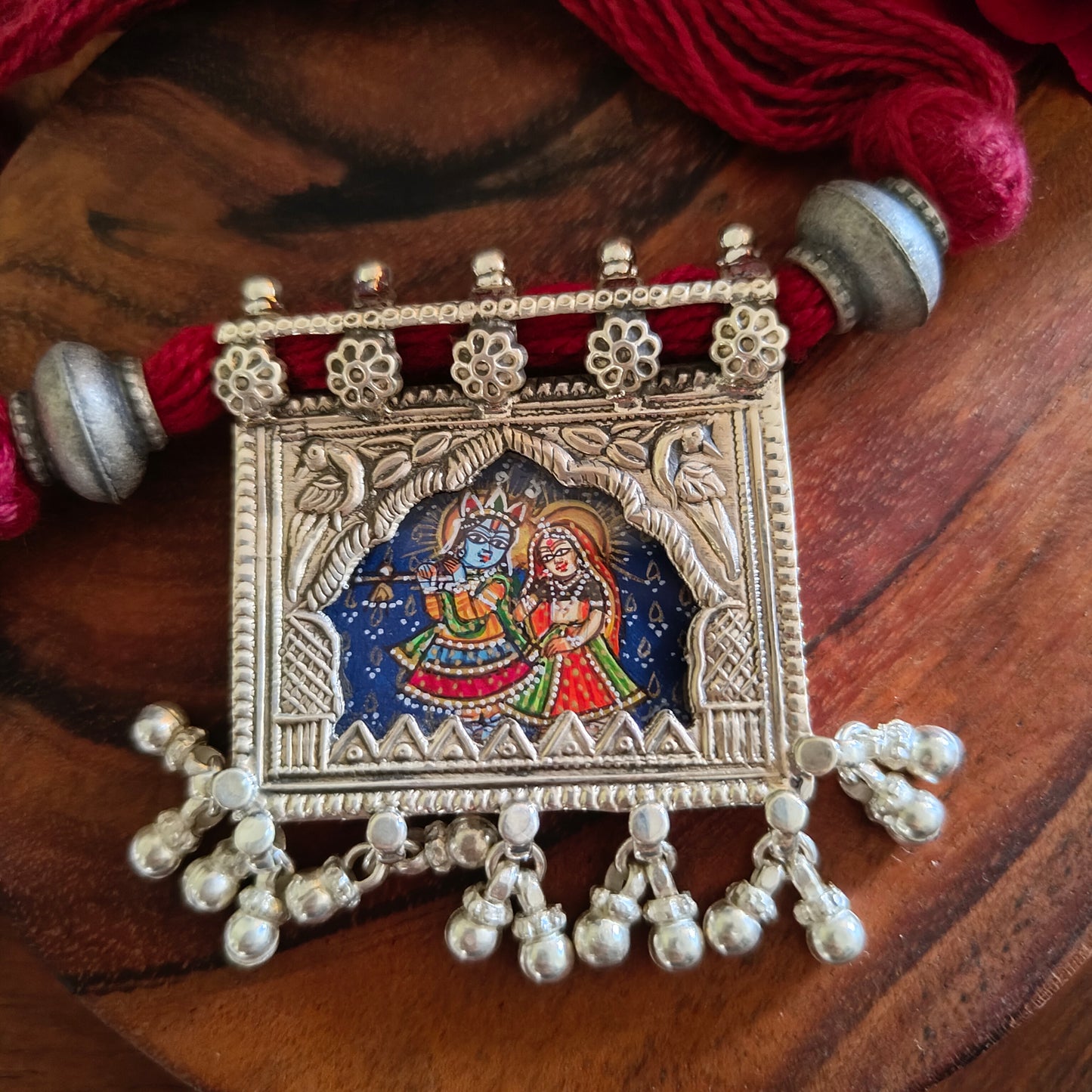 Radha Krishna Hand Painted Jharoka Pendant with Silver Ball Danglers and Maroon Thread Necklace Blue Bg