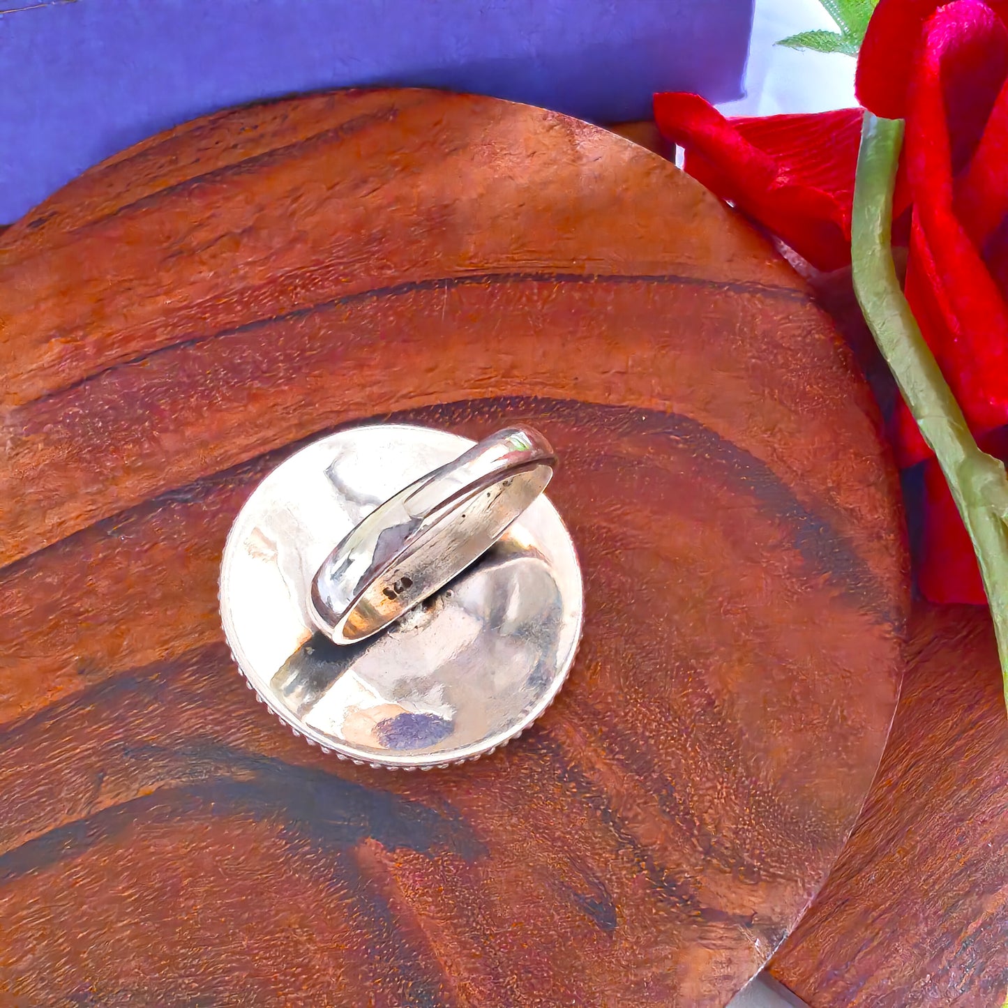 Circular Ring With Embossed Rava Design And Green Stone