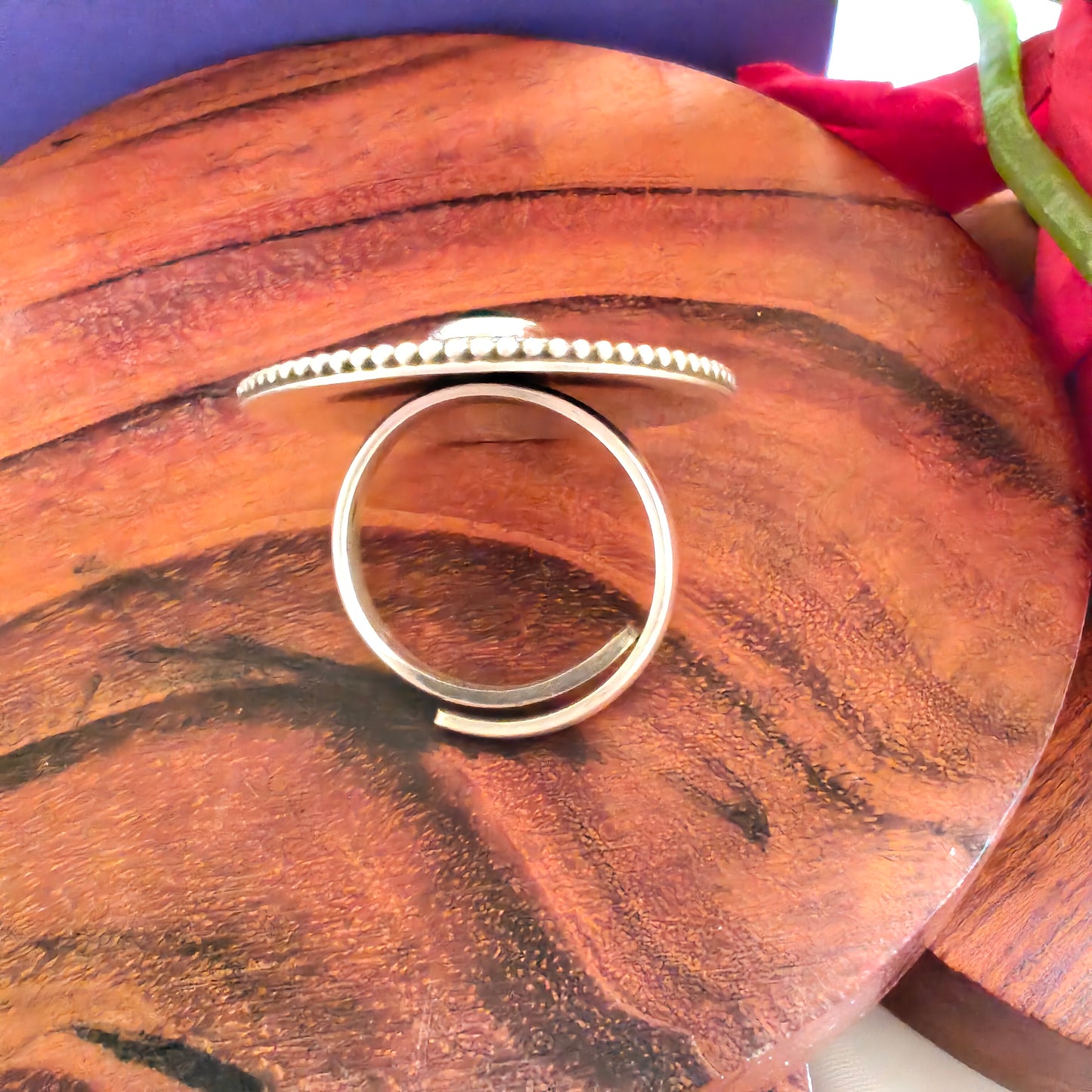 Circular Ring With Embossed Rava Design And Green Stone