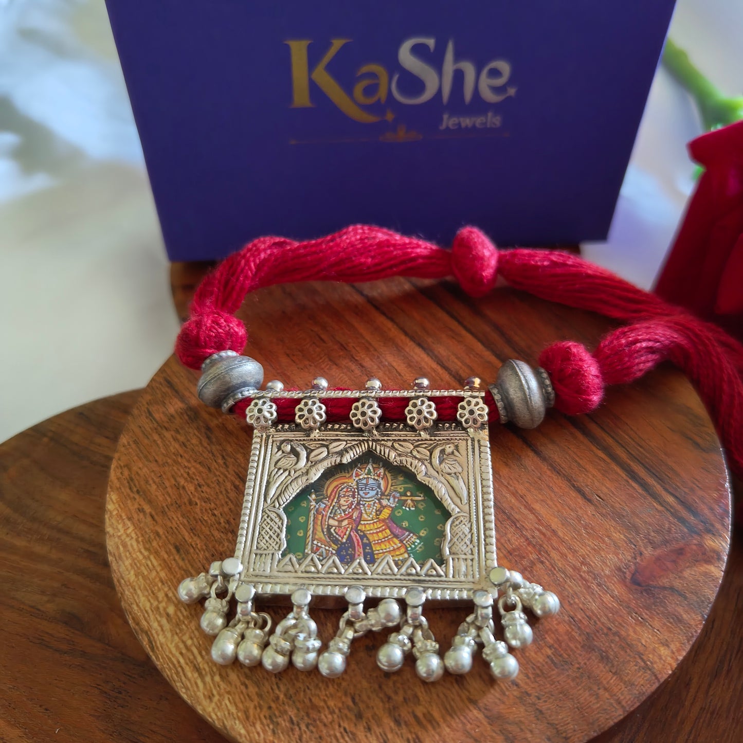 Radha Krishna Hand Painted Jharoka Pendant with Silver Ball Danglers and Maroon Thread Necklace Green Bg