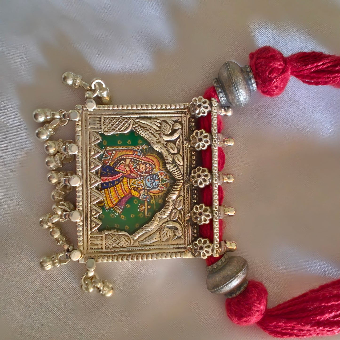 Radha Krishna Hand Painted Jharoka Pendant with Silver Ball Danglers and Maroon Thread Necklace Green Bg