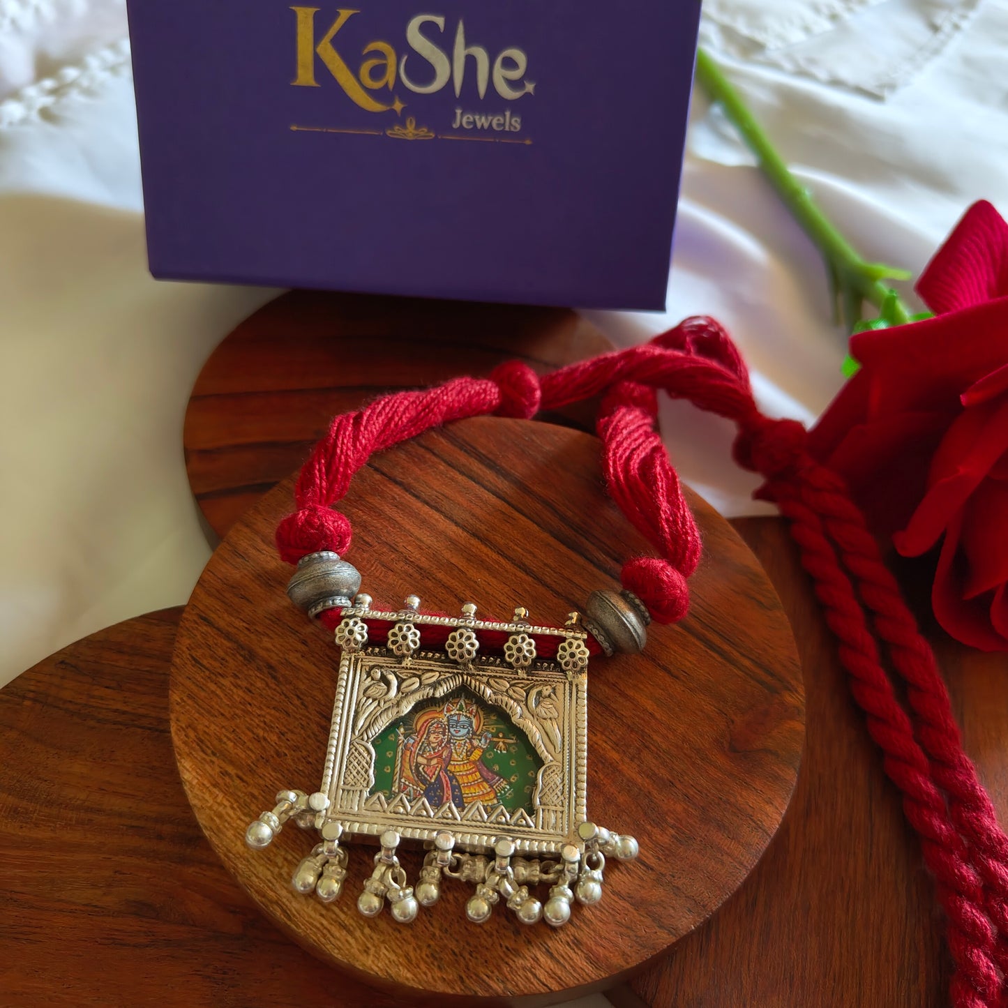 Radha Krishna Hand Painted Jharoka Pendant with Silver Ball Danglers and Maroon Thread Necklace Green Bg