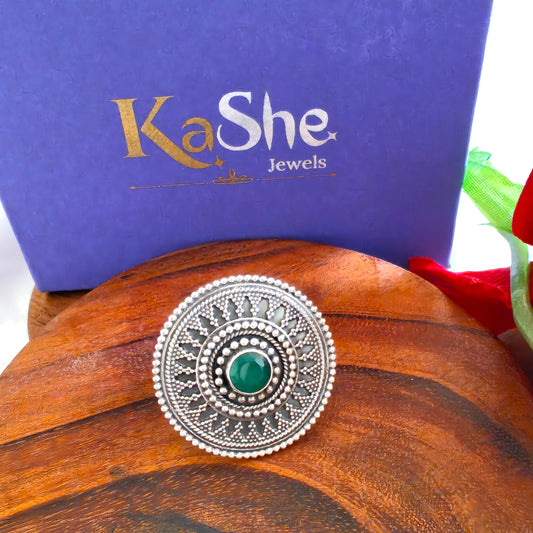 Circular Ring With Embossed Rava Design And Green Stone