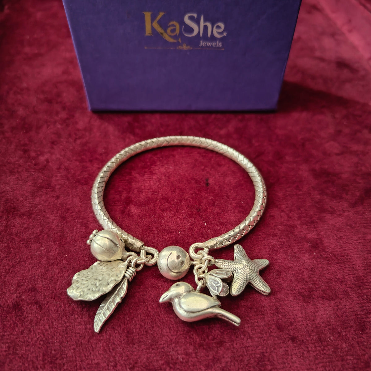 Exclusive Braided Sterling Silver Charms Kada With Bird, Flower, Leaves, Buds, Smiley And Star